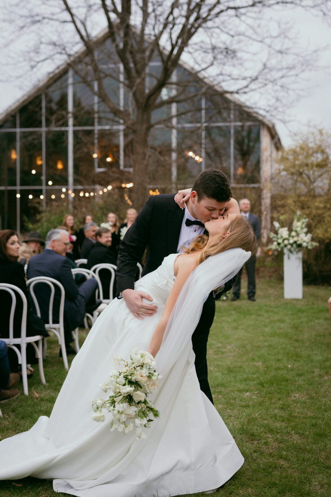 bride and groom kissing exiting wedding ceremony