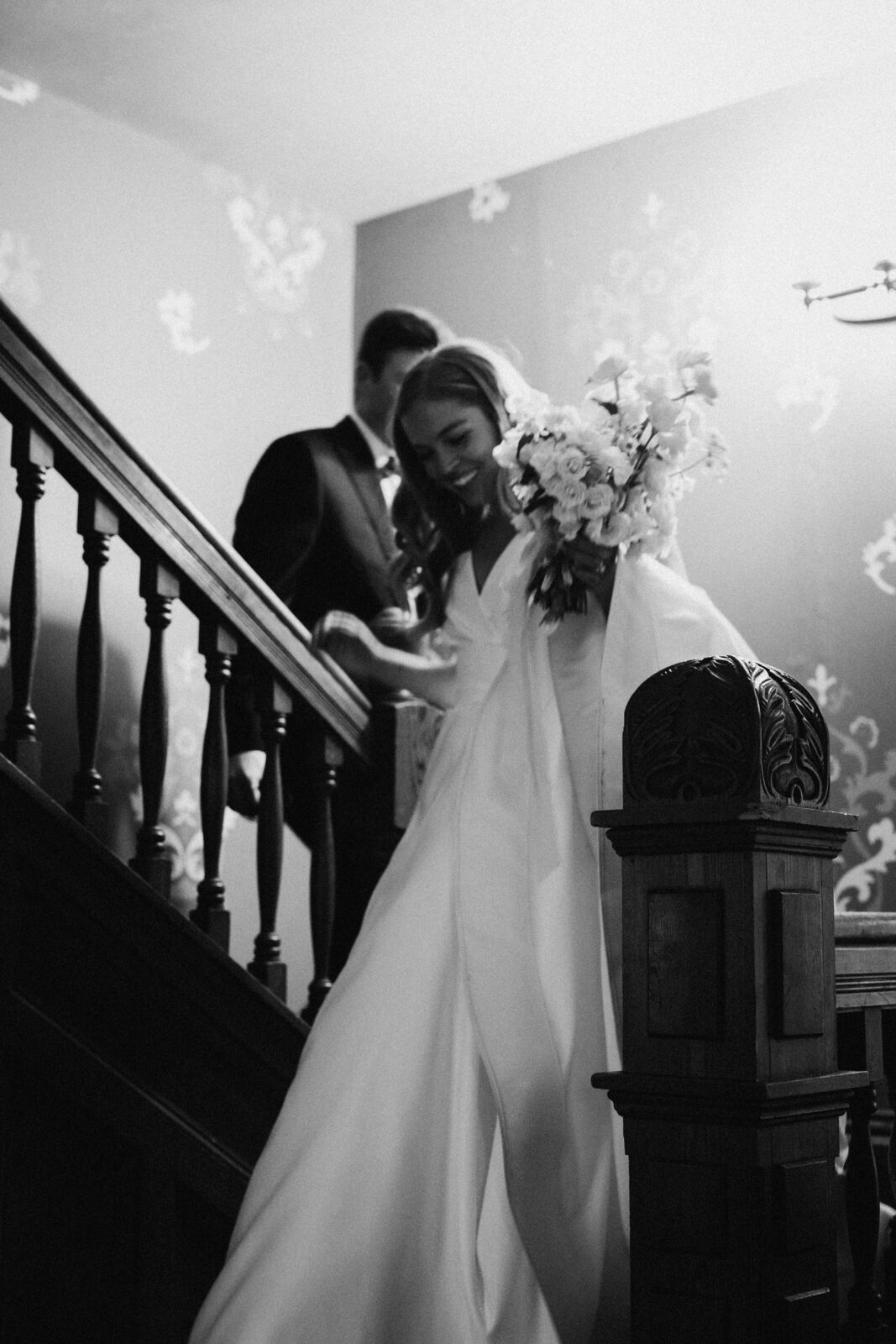 bride and groom walking down staircase